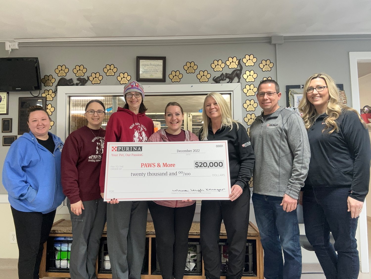 The Nestle Purina PetCare team (on right) presented the PAWS & More team (on left) with $20,000 toward construction of a new animal shelter building.